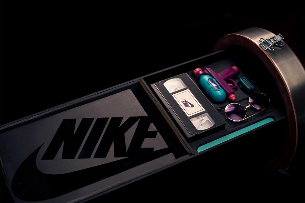 time capsule designed by Petey Petersen for Nike Time Capsule Project for the Nike Air Max shoe launch the lime capsule is open showing the Nike logo a NIKE VHS tape round purple glasses a water gun and the NIKE Air Max shoe box photographer Maria Bruun